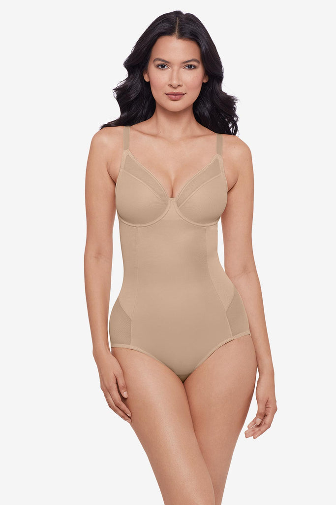 Woman wearing warm beige one-piece shapewear