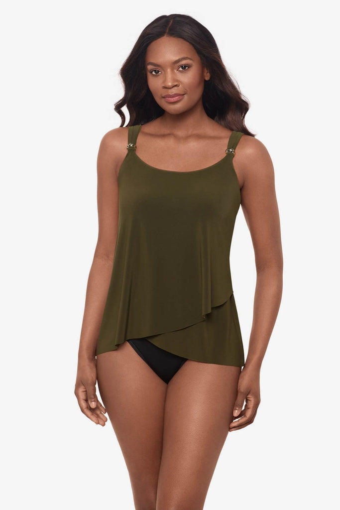 Woman wearing a nori green tankini top with details on the straps