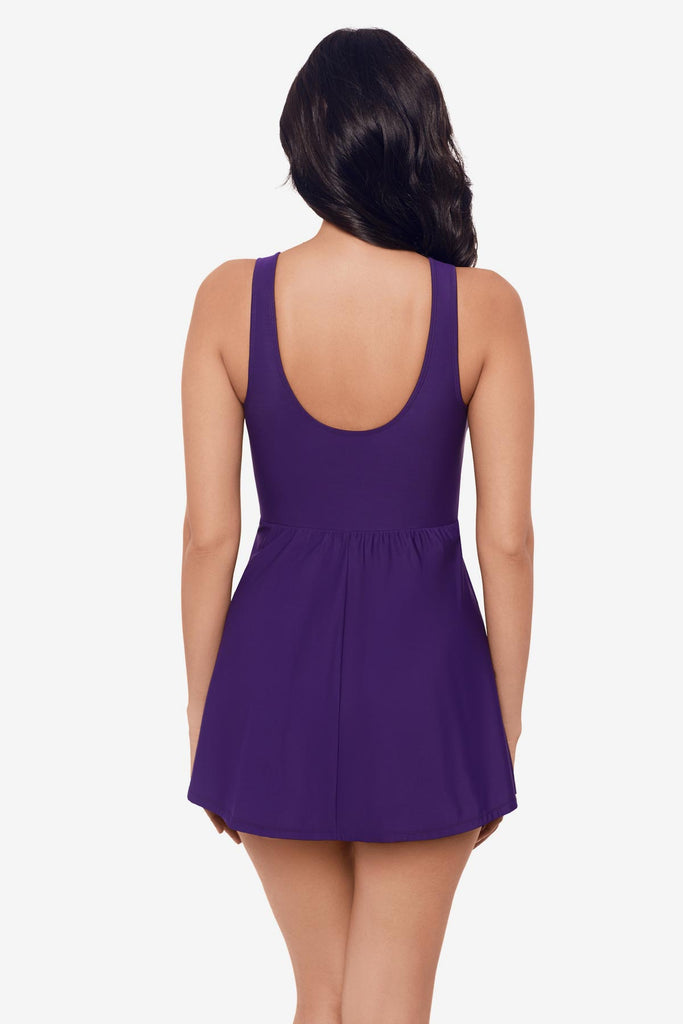 Woman turned away wearing a mulberry purple swim dress 