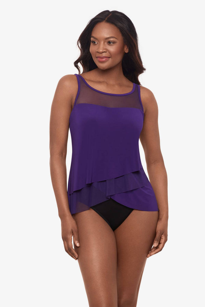 Woman wearing a mulberry purple tankini top with a mesh neckline 