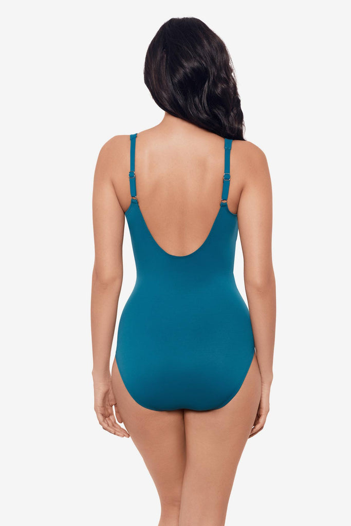 Woman facing away wearing an aegean blue one-piece swimsuit 