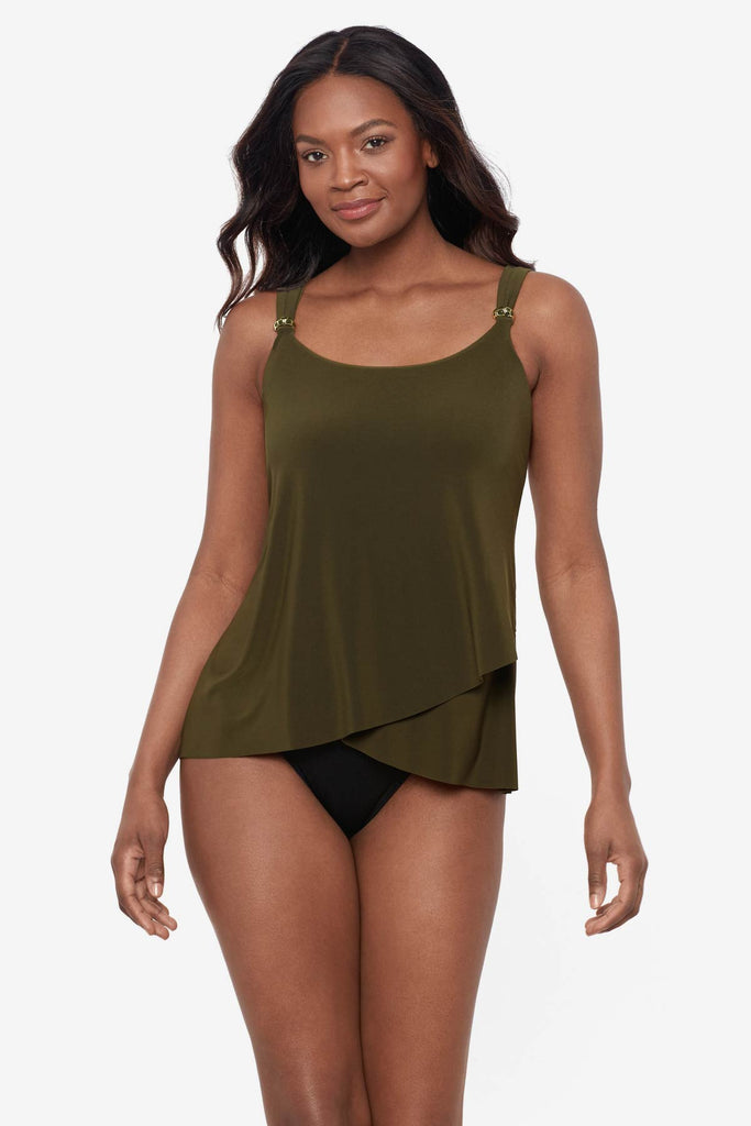 Woman wearing a nori green tankini top with details on the straps