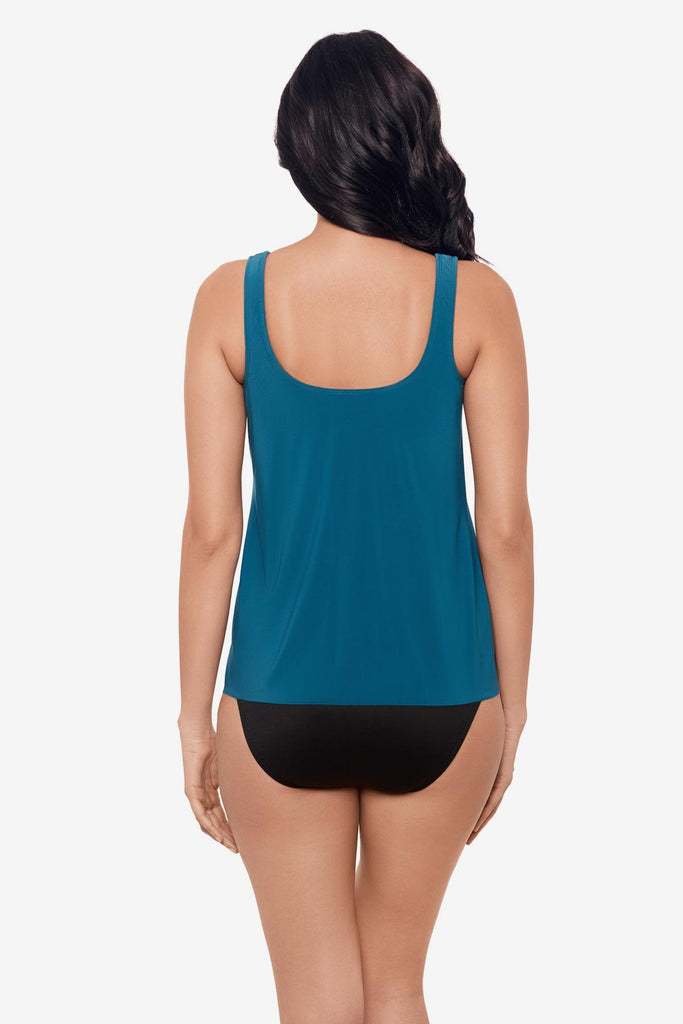 Woman facing away wearing aegean blue tankini top with layer fabric