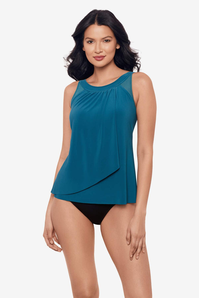 Woman wearing aegean blue tankini top with layer fabric