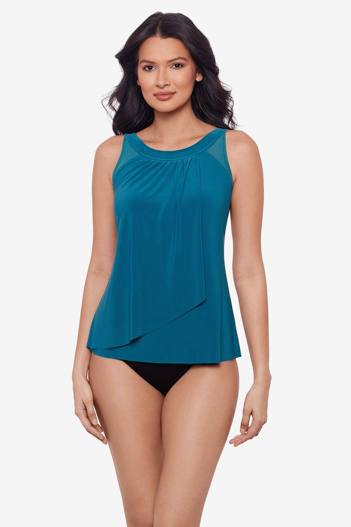 Woman wearing an aegean blue tankini top with draped fabric