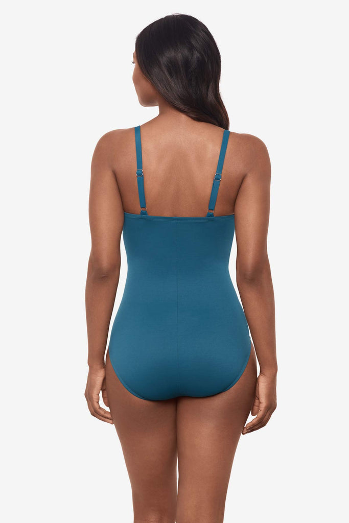 Woman looking away wearing an aegean blue one-piece swimsuit 