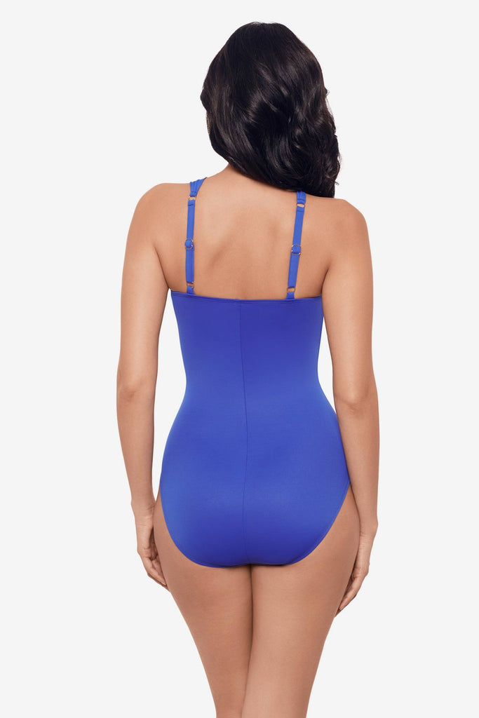 Woman facing away wearing a delphine blue one-piece swimsuit 