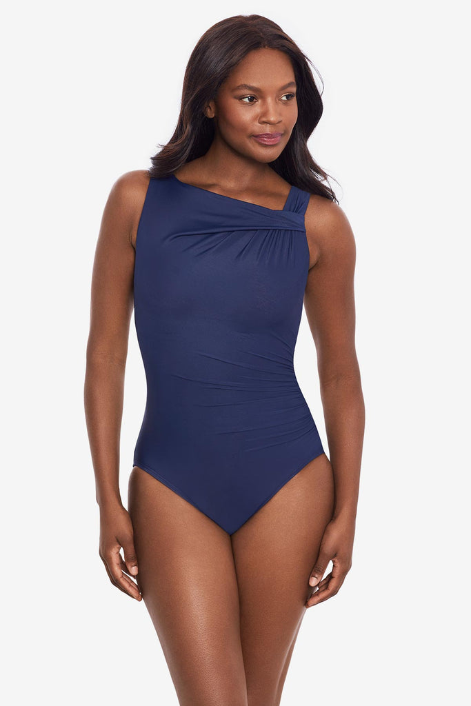 Woman wearing an midnight blue one-piece swimsuit with a high neckline