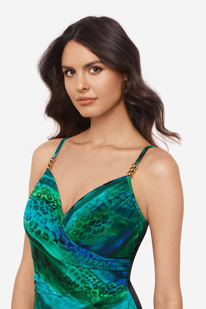 Close up of woman wearing multicolor one-piece swimsuit with details on the straps