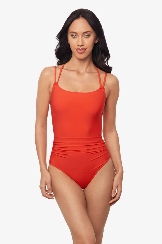 Woman wearing a blaze orange one-piece swimsuit with double straps