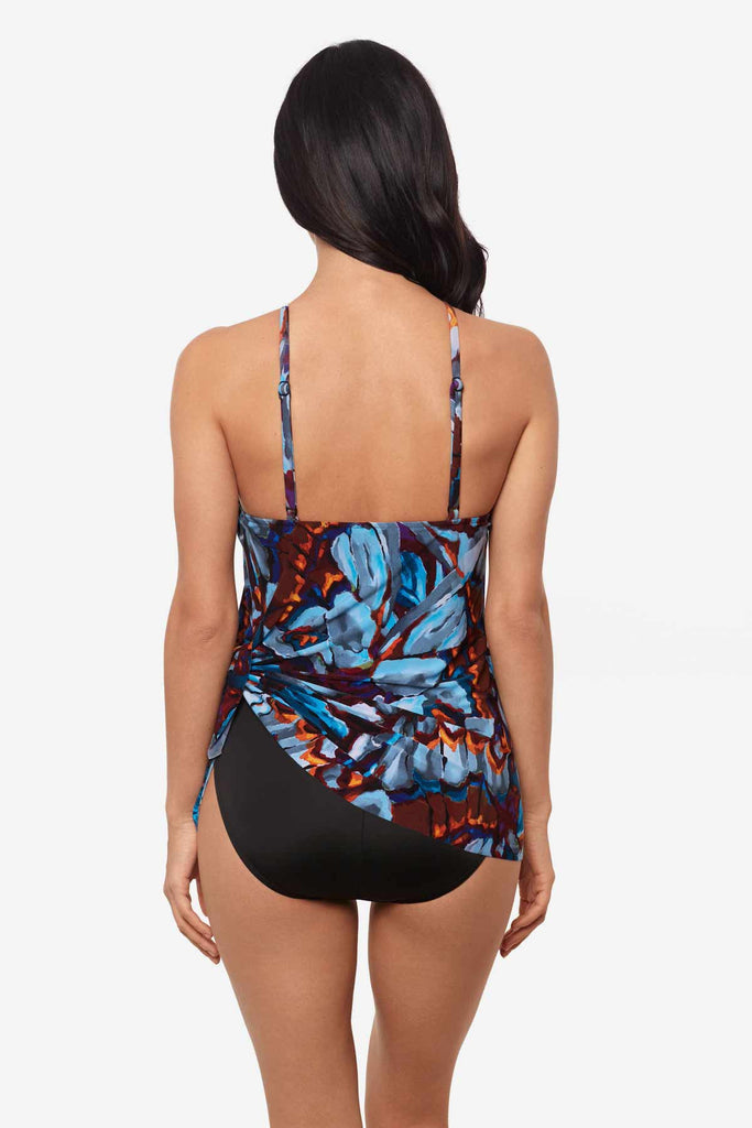 Woman faced away wearing a multicolor one-piece swimsuit