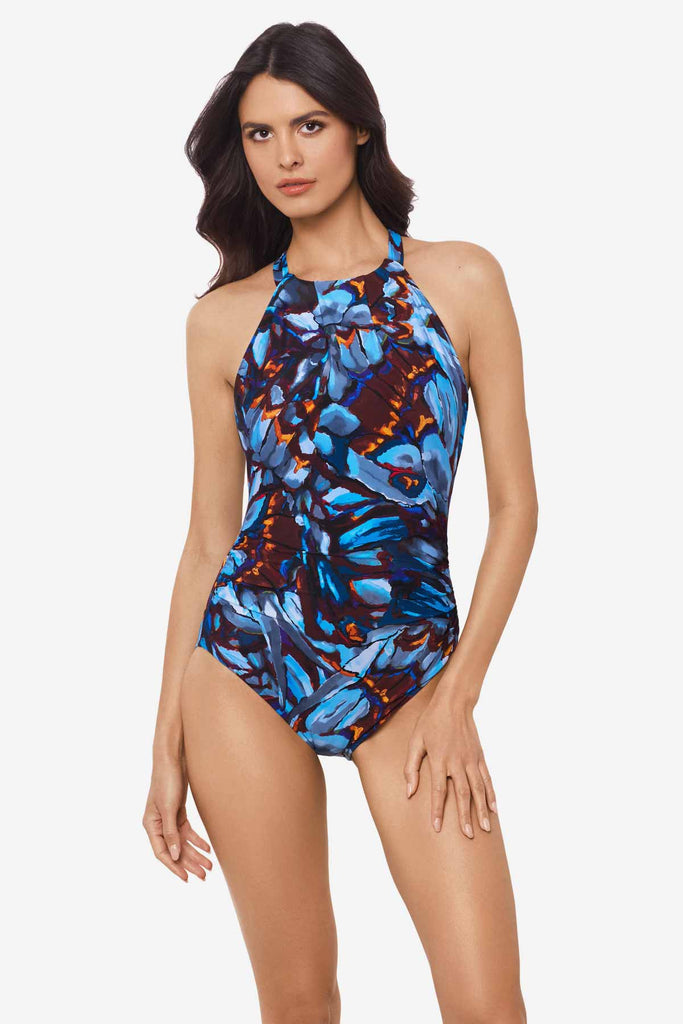 Woman wearing a multicolor one-piece swimsuit with an abstract floral print