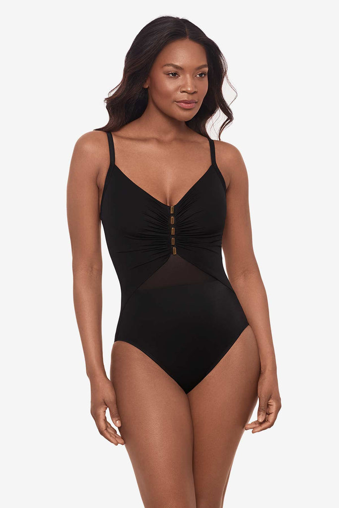 Woman wearing an all-black one-piece swimsuit with a mesh detail on the front