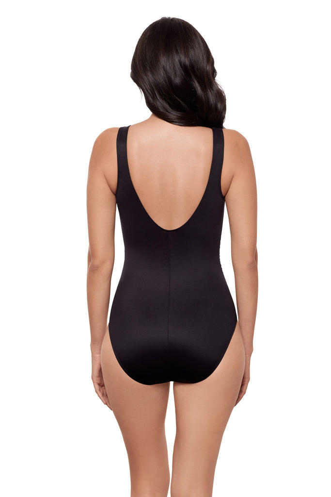 Woman turned away wearing a black one-piece swimsuit