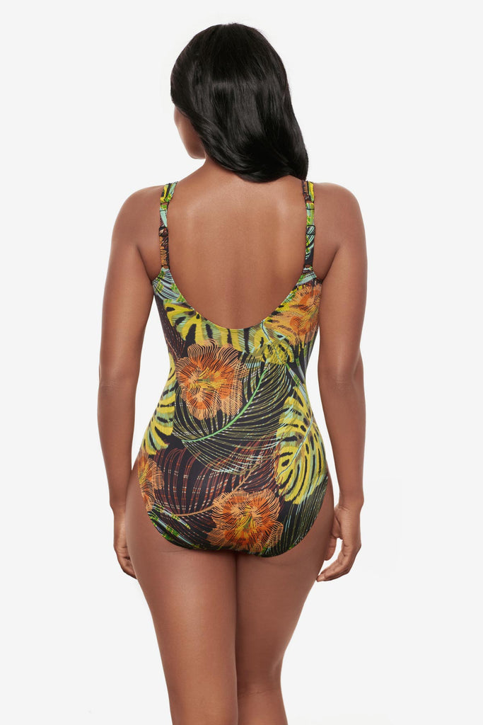Woman turned away wearing a multicolored palm leaf printed one-piece swimsuit