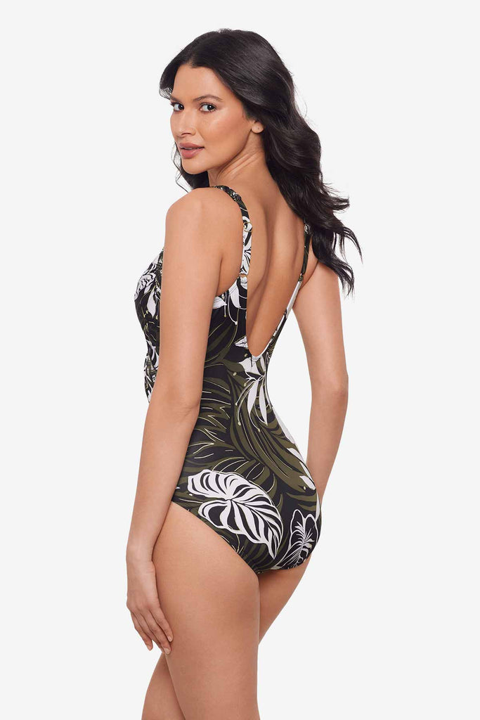 Woman turned to the left to show off the side of the multicolor one-piece swimsuit