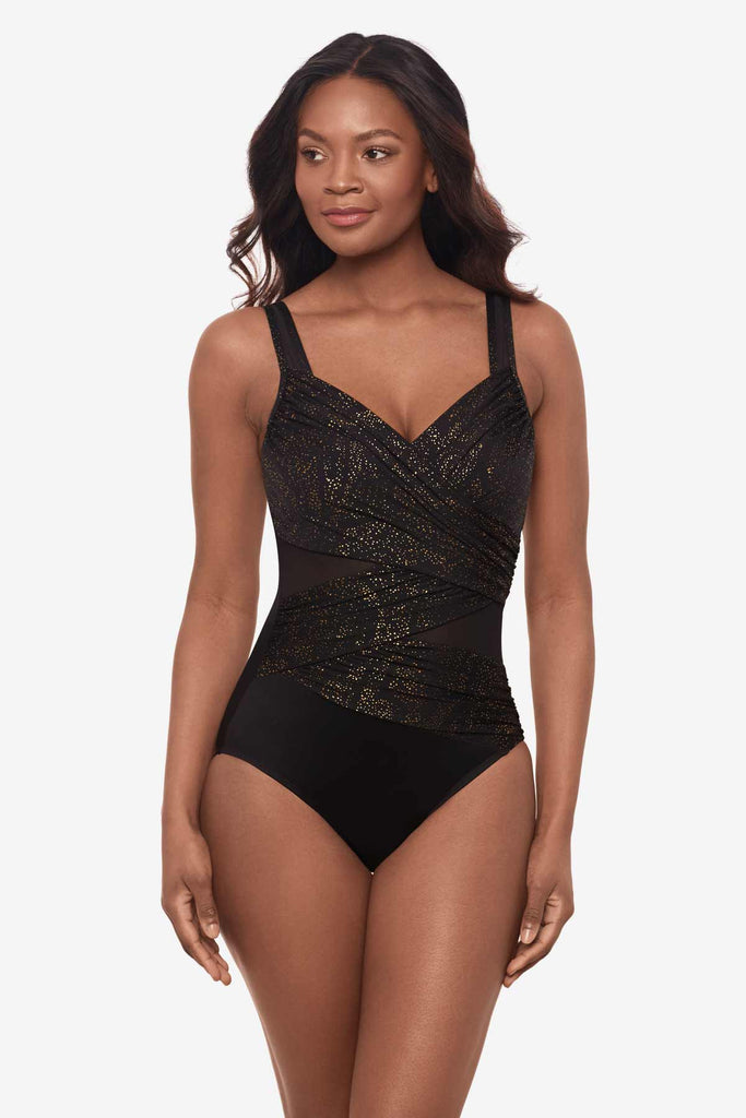 Woman looking left wearing a one-piece swimsuit with shimmer fabric