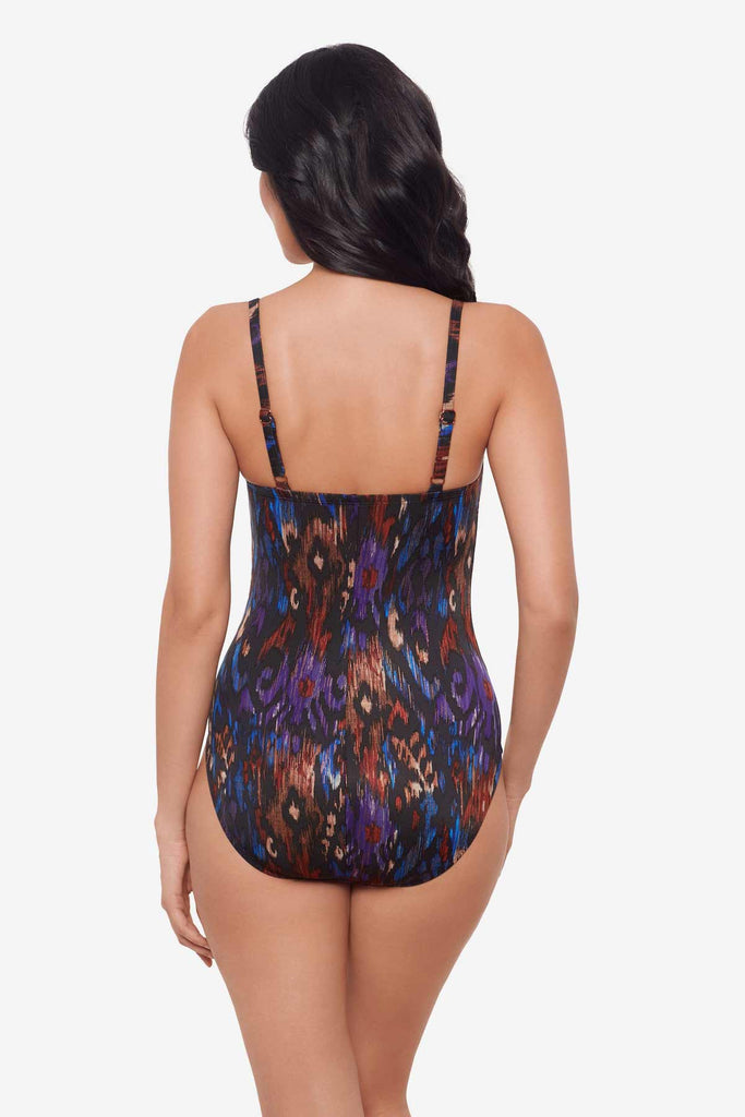 Woman turned away showing off the back of the one-piece multicolored swimsuit