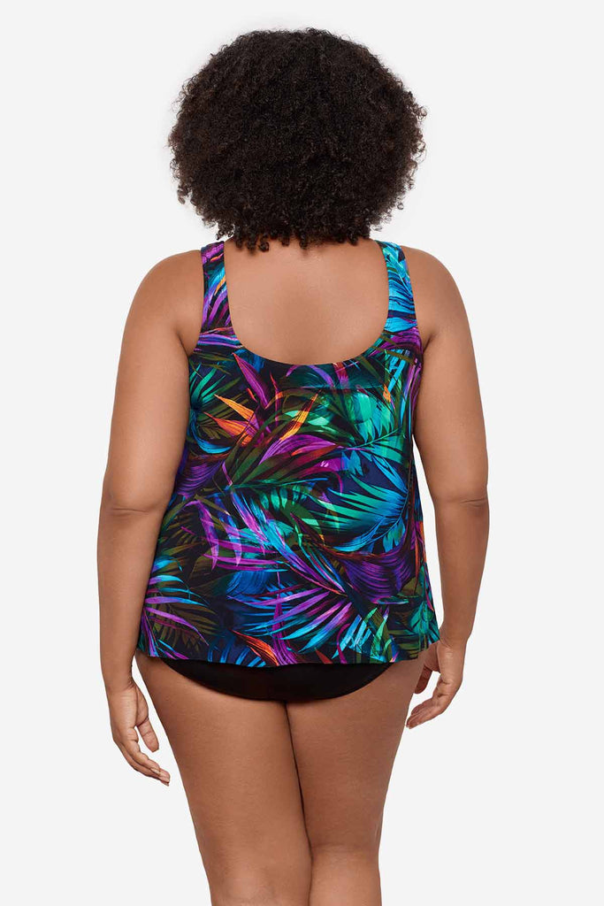 Woman turned away wearing a multicolor tankini top with neon palm leaves