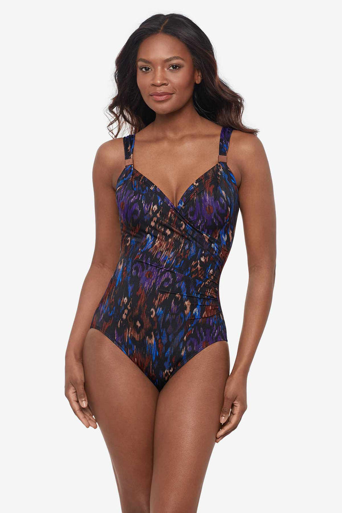 Woman wearing a multicolored one-piece swimsuit with strap details