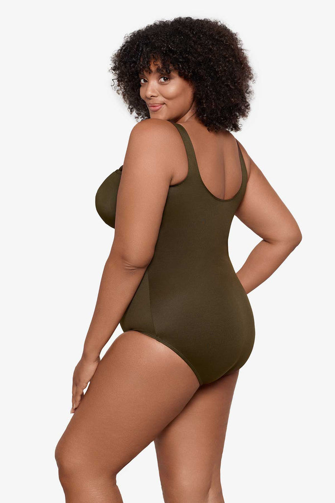 Woman turned left to show side detail of the one-piece swimsuit