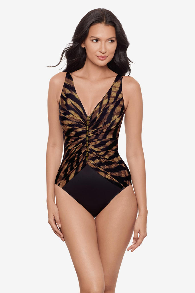 Woman wearing a black and brown printed one-piece swimsuit