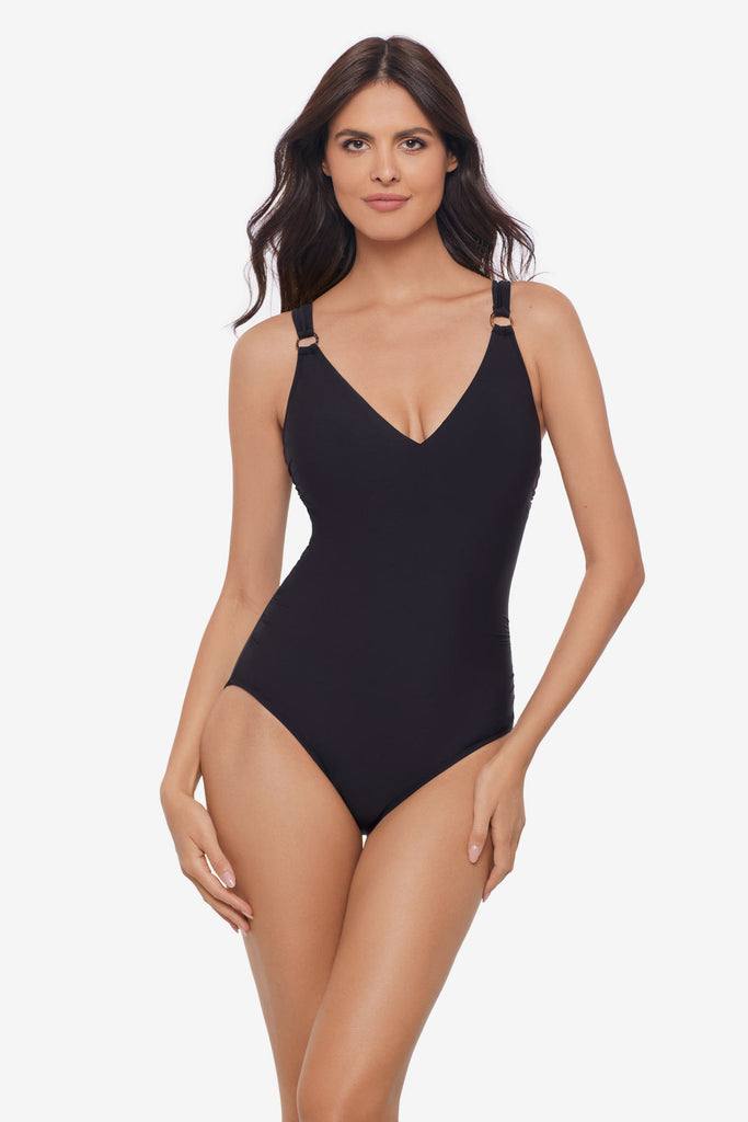 Woman wearing a black one-piece swimsuit with O rings on the straps