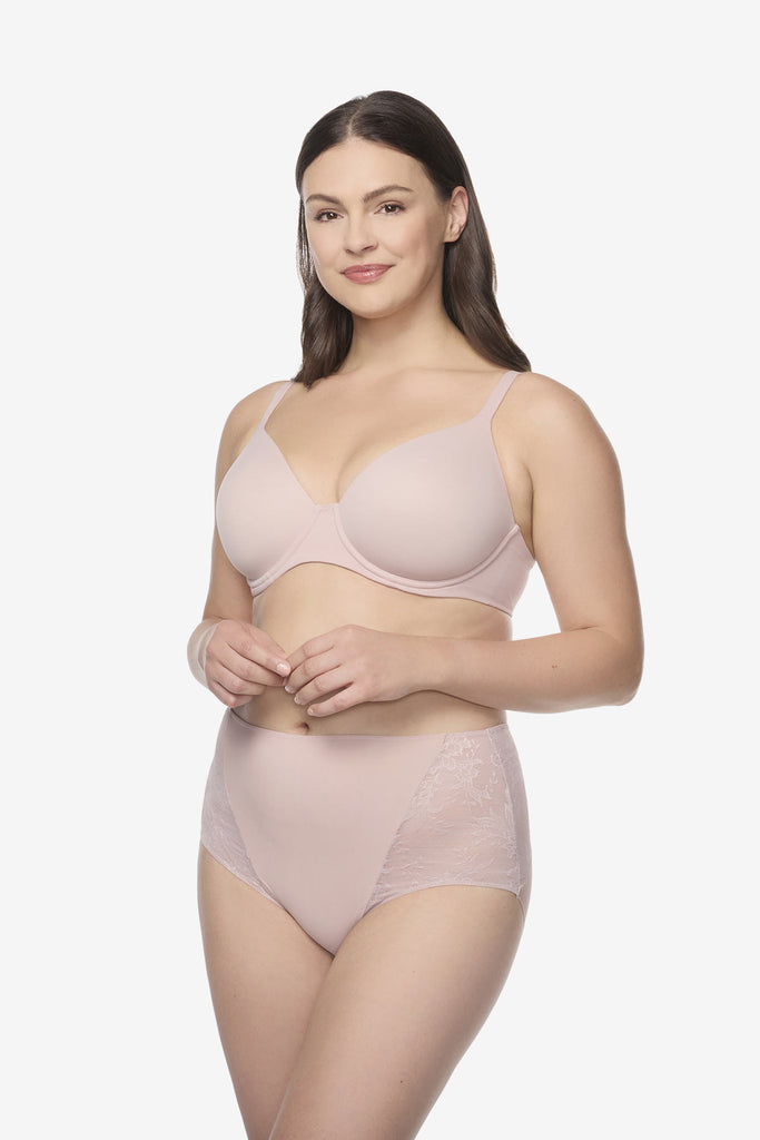 Woman wearing light pink brief shapewear bottoms
