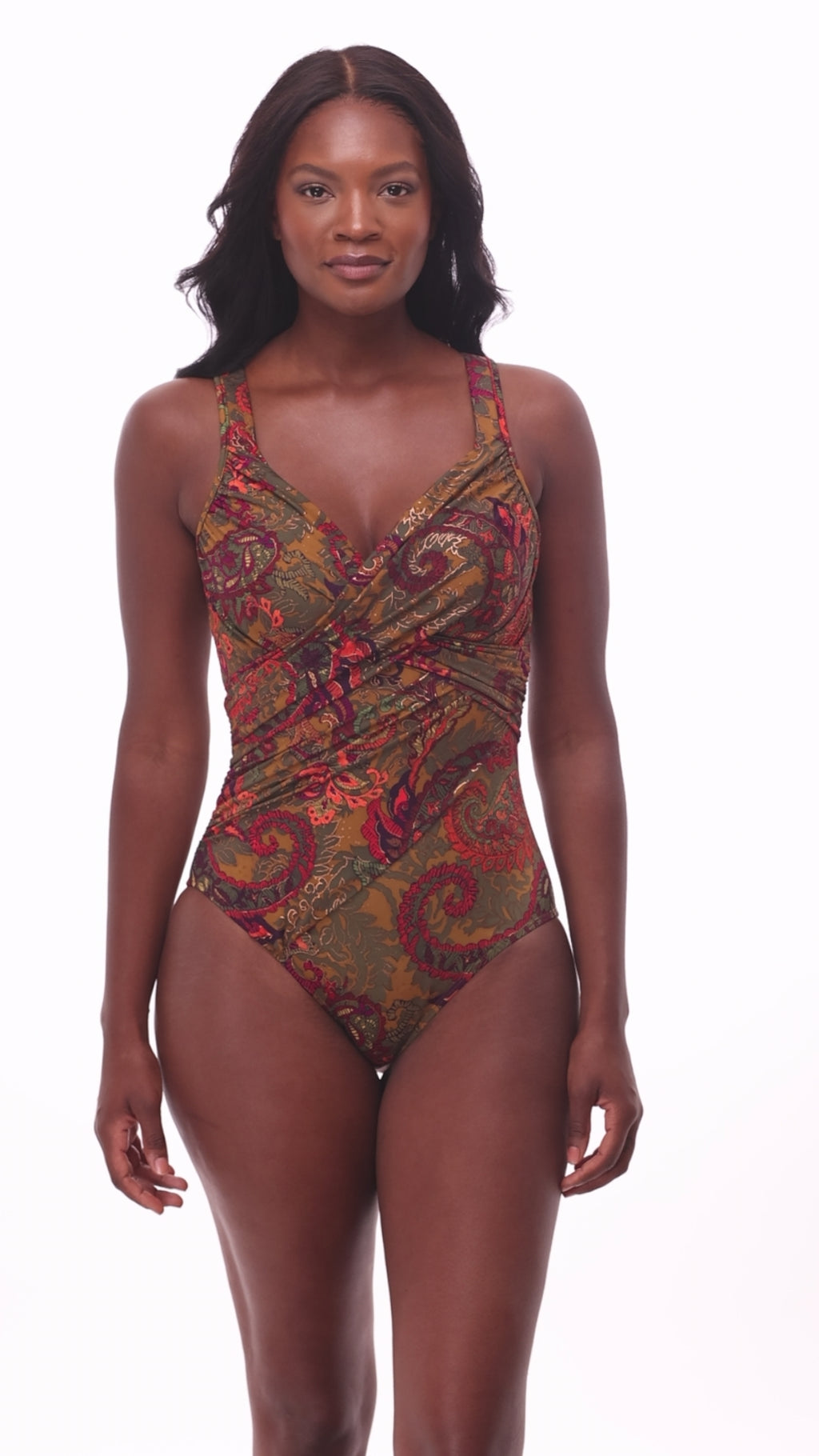 Woman wearing a multicolored paisley printed one-piece swimsuit with a sweetheart neckline