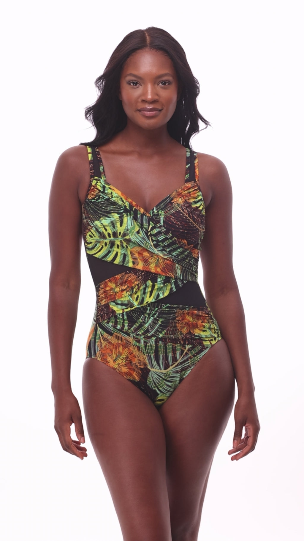 Woman wearing a multicolored palm leaf printed one-piece swimsuit