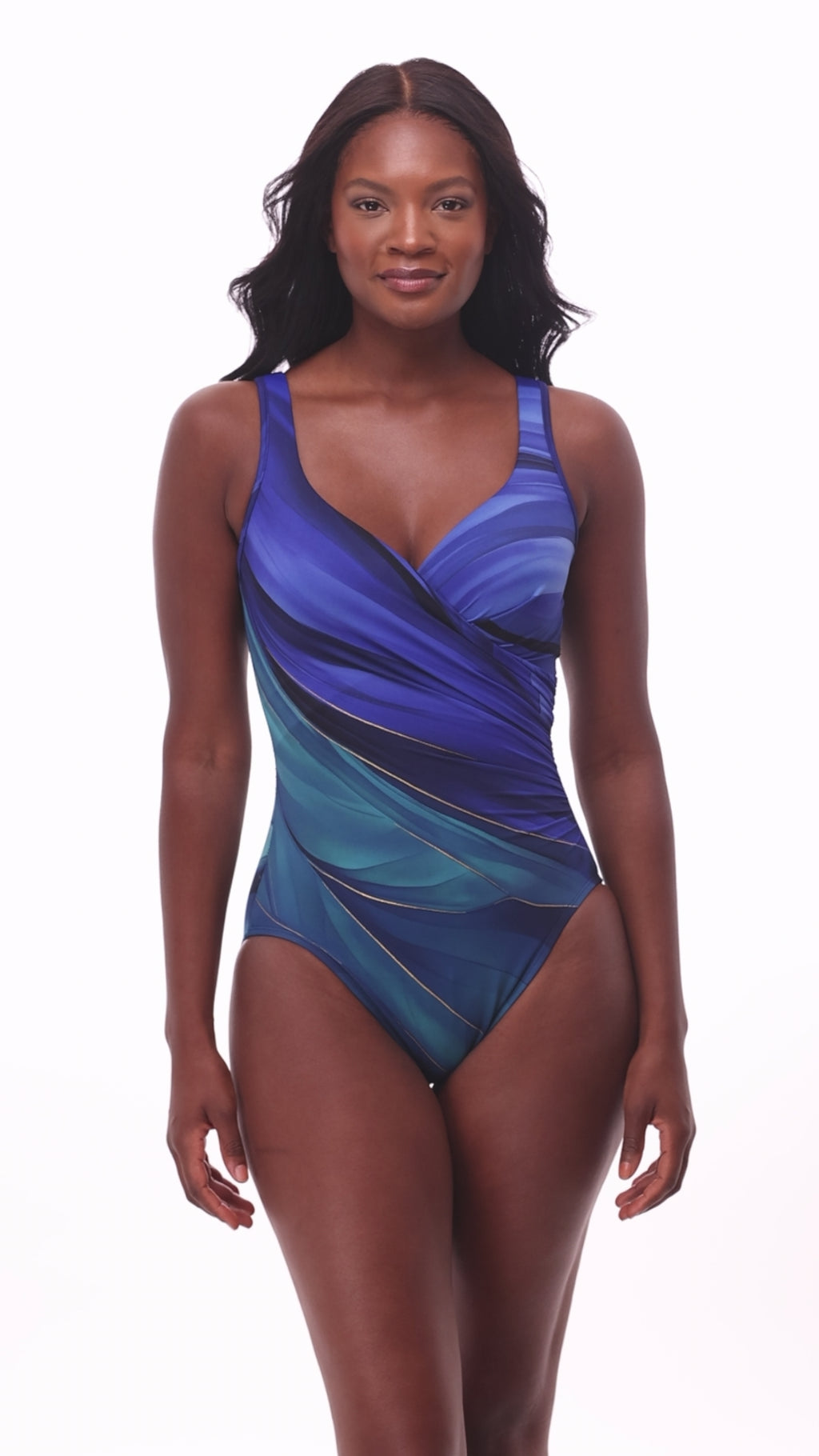 Woman wearing a multi-blue one-piece swimsuit with gold details